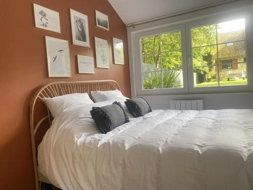 a bed in a bedroom with pictures on the wall at Gîte Thoiry, 4 pièces, 6 personnes - FR-1-527-6 in Thoiry
