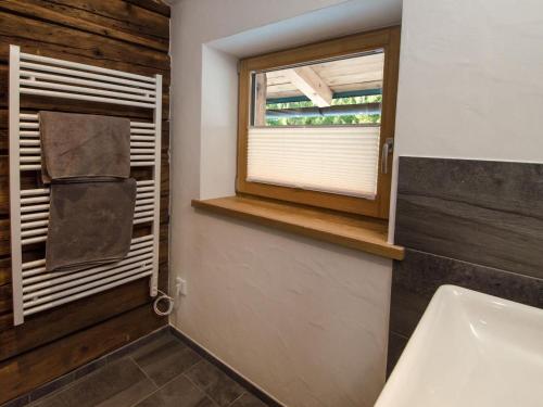 a bathroom with a window and a sink at Large hut in the Pinzgau with a great view and its own sauna hut in Dorf