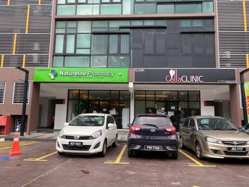 three cars parked in a parking lot in front of a building at The Icon2 Condo in IOI City Mall Putrajaya, Pool View in Putrajaya