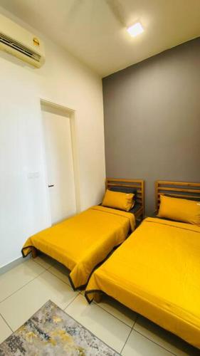 two beds sitting next to each other in a room at The Icon2 Condo in IOI City Mall Putrajaya, Pool View in Putrajaya