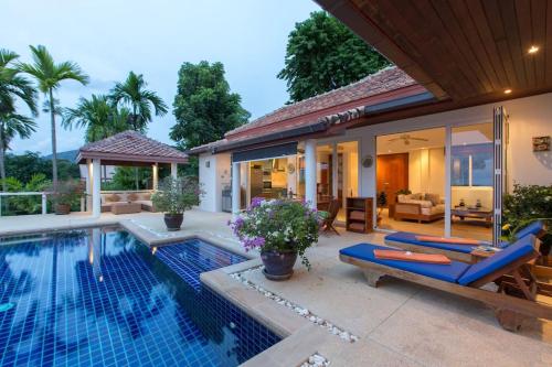 a villa with a swimming pool and a house at Katamanda villa Moon 3 Bed seaview near Kata Beach in Kata Beach