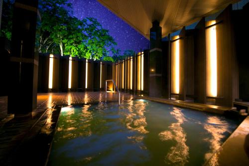 a swimming pool with lights in a building at Niseko Northern Resort, An'nupuri in Niseko