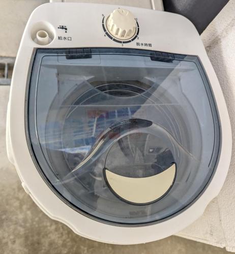 a washing machine with a smile on the front at Shima Stay holoholo in Zamami