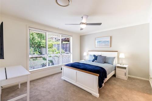 een slaapkamer met een bed en een raam bij 74A Sergeant Baker Drive comfortable duplex with beautiful distant water views in Corlette