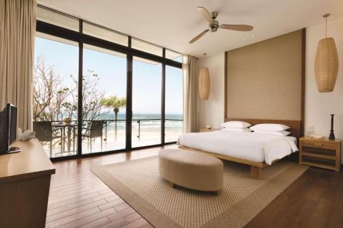 a bedroom with a bed and a view of the ocean at Villa seaview and apartment Da Nang by JT group in Da Nang