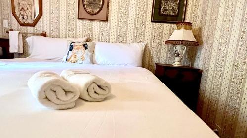 a bedroom with a bed with towels on it at Hotel La More at The Bisbee Inn in Bisbee