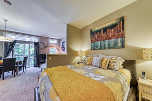 a bedroom with a bed and a dining room at Belltown Court Space Needle Studio in Seattle