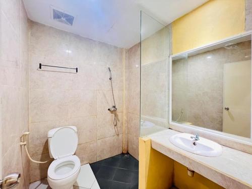 a bathroom with a toilet and a sink and a shower at RedDoorz near Alun Alun Sidoarjo in Sidoarjo