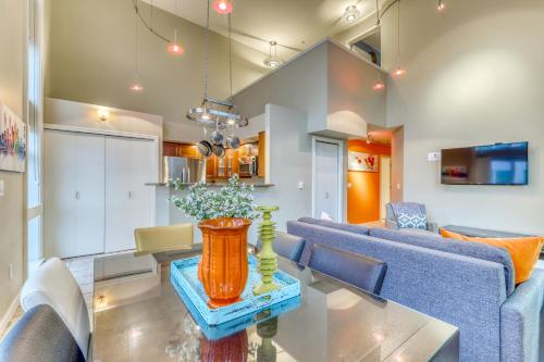 a living room with a table and a blue couch at Belltown Court Sunset Suite in Seattle