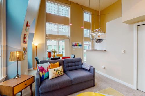 a living room with a couch and a table at Belltown Court Sunset Suite in Seattle