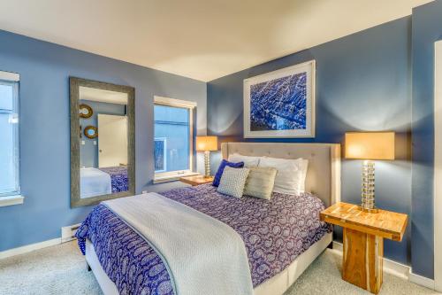 シアトルにあるBelltown Court Sunset Suiteのベッドルーム1室(ベッド1台、ランプ2つ、鏡付)