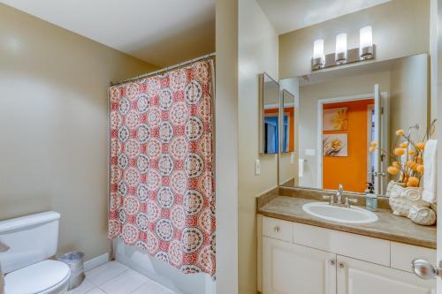 a bathroom with a sink and a shower curtain at Belltown Court Sunset Suite in Seattle