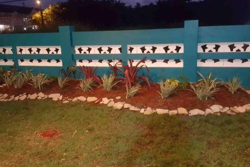 a fence with birds on it in a yard at Beach House In Crown Point- walk to the beach in Bon Accord