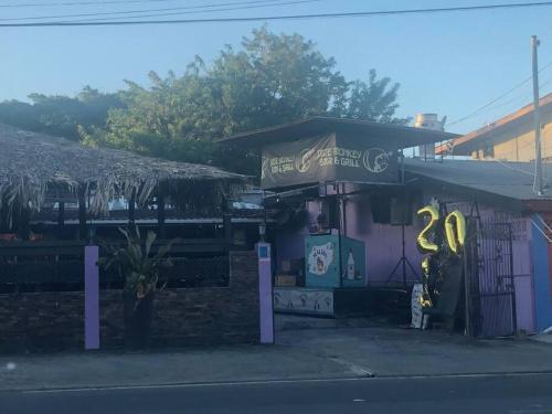 a gas station with a couple of yellow signs on it at Beach House In Crown Point- walk to the beach in Bon Accord
