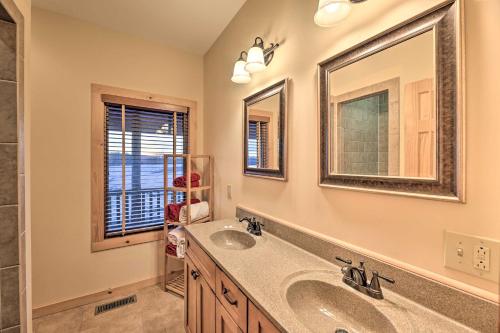 a bathroom with two sinks and a mirror at Spacious Slaty Fork Home about 12 Mi to Snowshoe in Slaty Fork