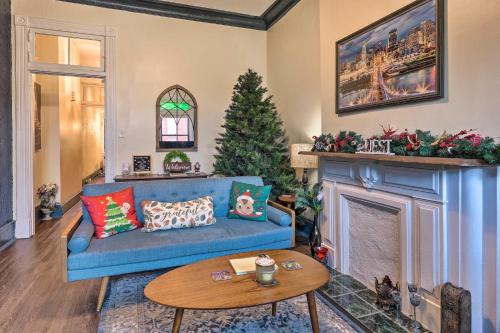 a living room with a blue couch and a christmas tree at Cincinnati Retreat with Patio and Grill! in Cincinnati