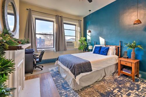 a bedroom with a bed and a blue wall at Cincinnati Retreat with Patio and Grill! in Cincinnati