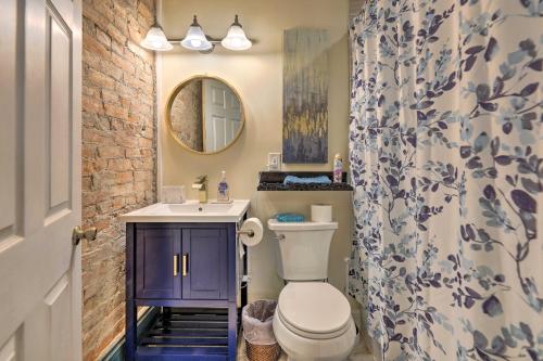 a bathroom with a toilet and a sink and a mirror at Cincinnati Retreat with Patio and Grill! in Cincinnati