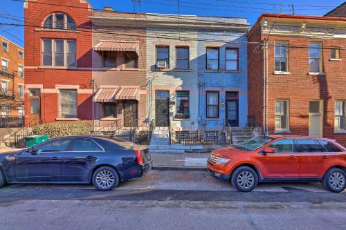 two cars parked in a parking lot in front of buildings at Cincinnati Retreat with Patio and Grill! in Cincinnati