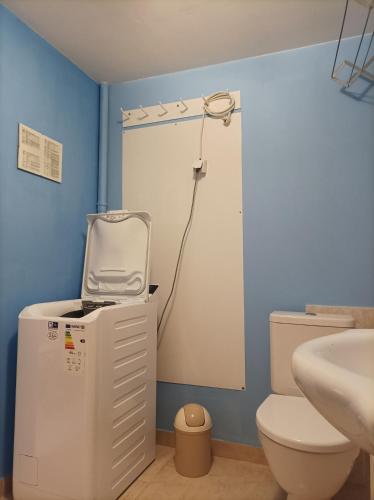 a bathroom with a white toilet and a sink at MotoHostel Wolter - apartmán Leme in Všeň