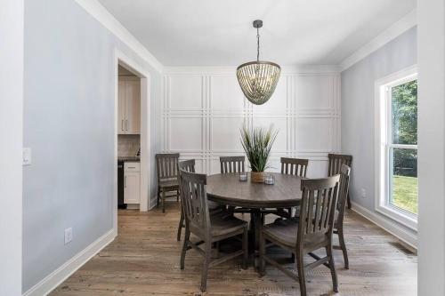 a dining room with a table and chairs at New Home, Dock, Home Theatre Projector, Hot Tub, Fire Pit, Kayaks in Winchester