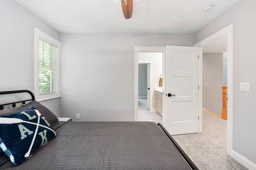 a bedroom with a bed and a white door at New Home, Dock, Home Theatre Projector, Hot Tub, Fire Pit, Kayaks in Winchester