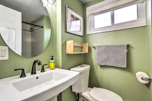 a bathroom with a sink and a toilet and a mirror at Centrally Located Denver Townhome Near Dtwn in Denver