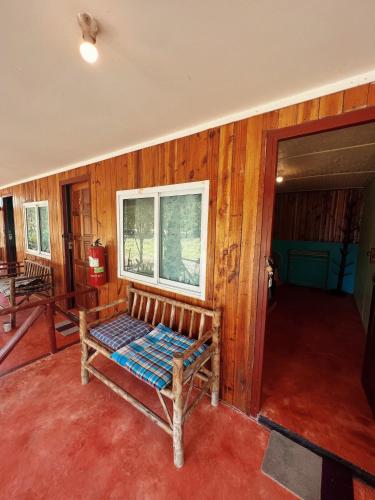 a bench in a room with wooden walls at LONELY GROOVE in Ko Chang