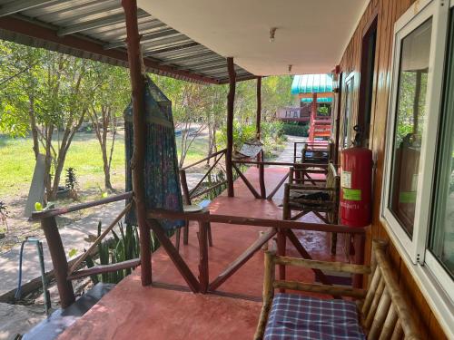 a porch of a house with a porch swing at LONELY GROOVE in Ko Chang