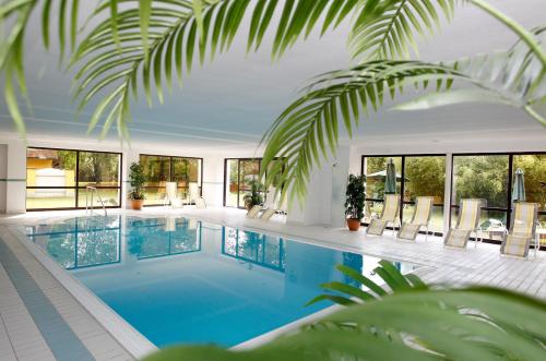 a swimming pool in a house with windows at Murhof Hotel in Frohnleiten