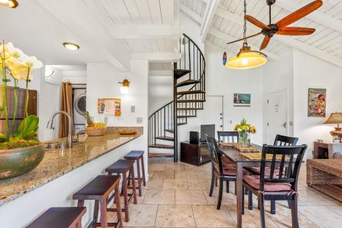 a kitchen and dining room with a table and chairs at Sandpiper 216A condo in Princeville