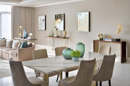 a dining room with a table and chairs at Address Fountain Views in Dubai