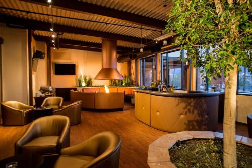a lobby with couches and chairs and a tree at Eureka Casino Resort in Mesquite
