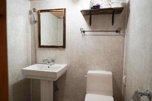 a bathroom with a sink and a toilet and a mirror at Samlockhon Hanokstay in Jeonju