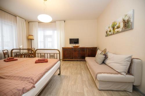 a living room with two beds and a couch at Libušina Villa in Kutná Hora