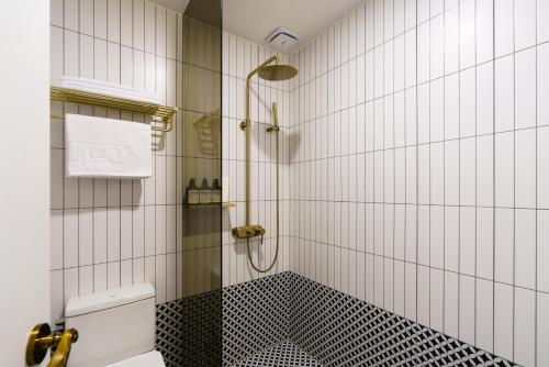 a bathroom with a shower and a toilet at Yangju Hotel Ippda in Yangju