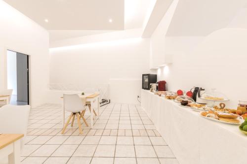 a white kitchen with a counter with food on it at La Gemma del Salento Rooms&Apartments in Racale