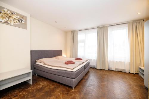 a bedroom with a bed and a large window at Libušina Villa in Kutná Hora