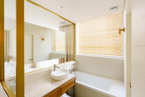 a bathroom with a sink and a mirror at Yangju Hotel Ippda in Yangju