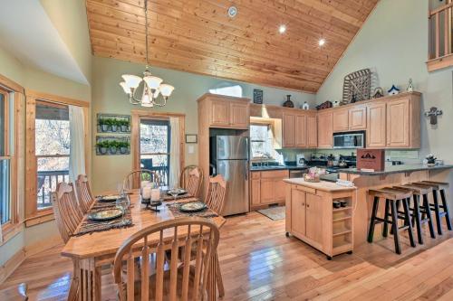 a kitchen with wooden cabinets and a table with chairs at Dahlonega Cabin with Hot Tub, 4 Mi to Downtown! in Dahlonega