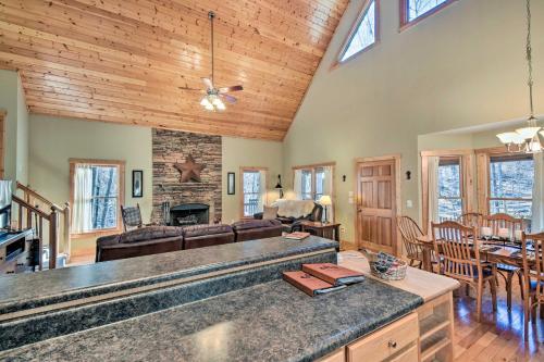 a kitchen and living room with a couch and a table at Dahlonega Cabin with Hot Tub, 4 Mi to Downtown! in Dahlonega