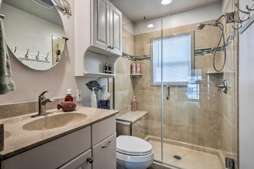 a bathroom with a shower and a toilet and a sink at Waterfront Lakeview Cottage with Dock and Lift! in Lakeview