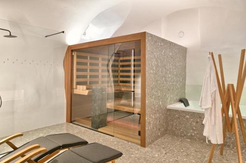 a glass shower in a room with chairs at Hisa 1624 - Adults Only in Zgornja Kungota