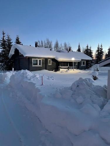 a house with a lot of snow in front of it at Yllästölli 2 D, Äkäslompolo in Kolari