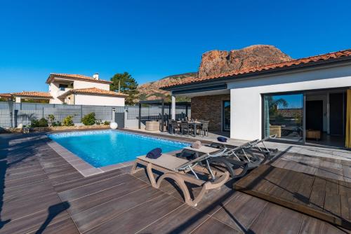 a backyard with a swimming pool and a house at Afa proche Ajaccio, magnifique villa avec piscine privée 8 personnes in Afa