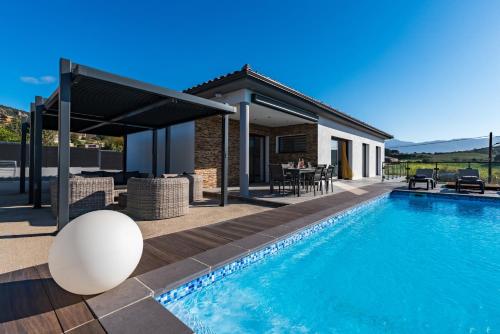 a villa with a swimming pool and a house at Afa proche Ajaccio, magnifique villa avec piscine privée 8 personnes in Afa