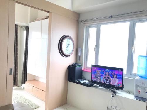 a living room with a tv and a window at smdc residences tagaytay tower 1 condo unit in Tagaytay