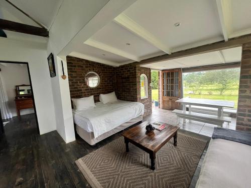 a bedroom with a bed and a coffee table at LionsGate Self-Catering Accommodation in Dargle