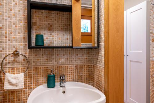 uma casa de banho com um lavatório e um espelho em Romantic Studio secret garden em Budapeste