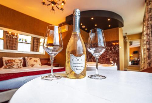 a bottle of wine and two glasses on a table at Hotel Johannes Vermeer Delft in Delft